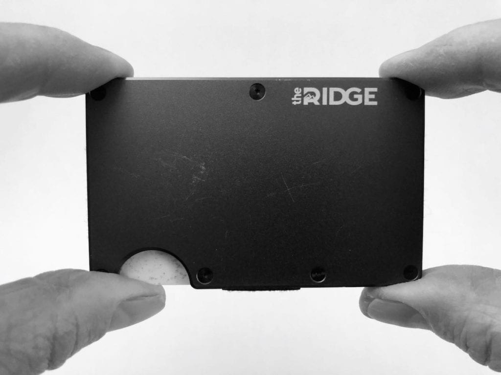 The Ridge cardholder wallet held by 4 fingers. 
