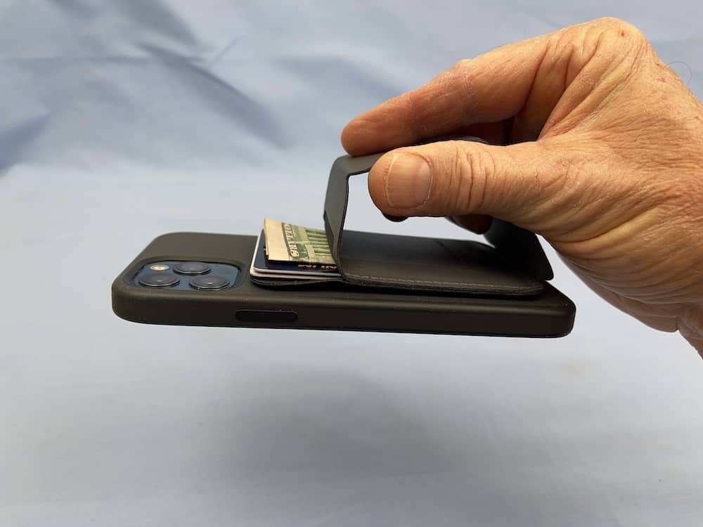 Holding the phone with the Moft wallet